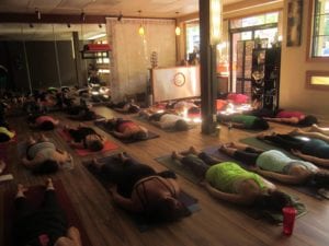 Holos Yoga full of yoga students laying down