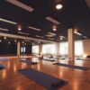 Inside shot of a yoga studio showing an example of infrared heaters for yoga studios mounted on the ceiling