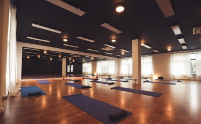 Inside shot of a yoga studio showing an example of infrared heaters for yoga studios mounted on the ceiling