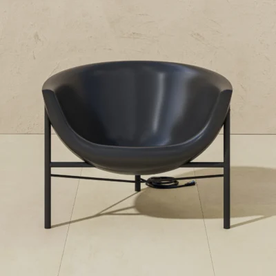 Black bowl-shaped salon sink on a metal stand, with an electrical cord on a beige tiled floor.