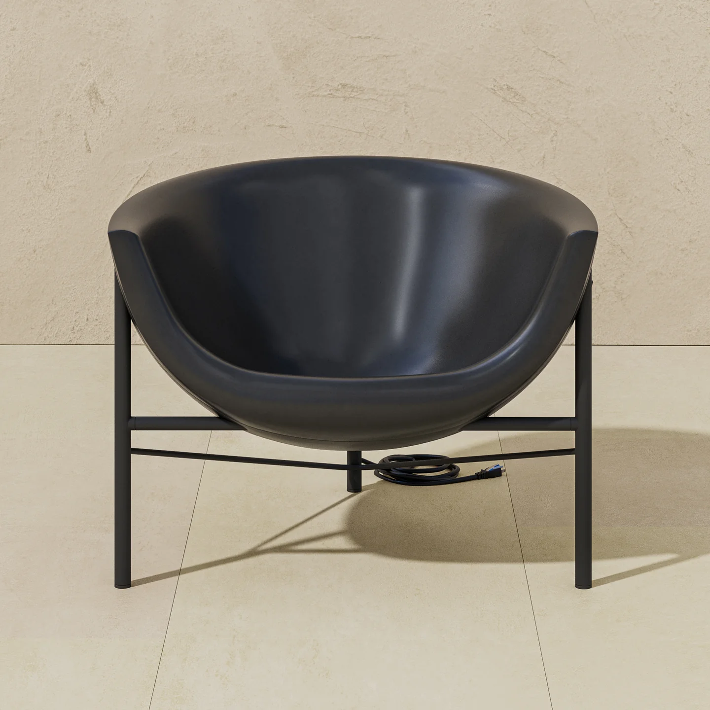 0003_GJ_KosmosChair2_Profile_.RGB_color.0000_1440x Black bowl-shaped salon sink on a metal stand, with an electrical cord on a beige tiled floor.