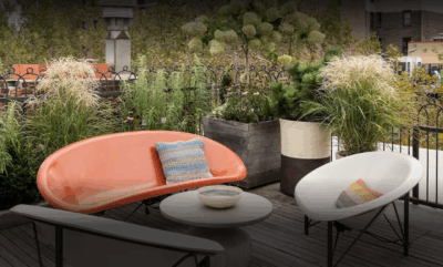 Several models of high-end heated furniture arranged on an outdoor patio