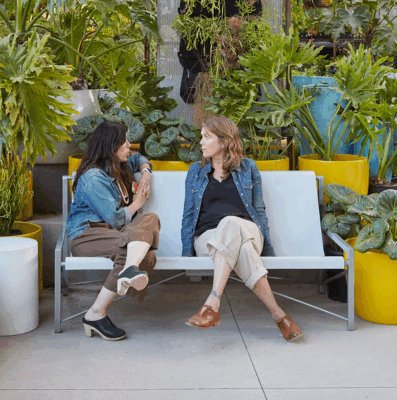 Women relaxing and talking while sitting on Galanter & Jones heated chairs from Heating Green
