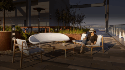 A woman sitting in an Evia Lounge next to the Evia Chair and Helios Lounge at an outdoor commercial space.