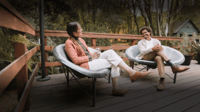 An happy couple seated in Helios chairs of Galanter & Jones heated furniture that is sold by Heating Green based in Bellingham, Washington