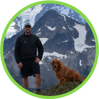 Photograph of Jeff Abel in the mountains with a dog