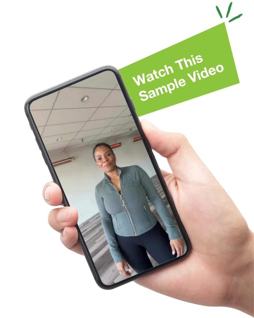 The text "Watch This Sample Video" next to a hand holding a mobile phone with an image of a woman in a yoga studio on the screen