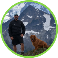 Photograph of Jeff Abel in the mountains with a dog